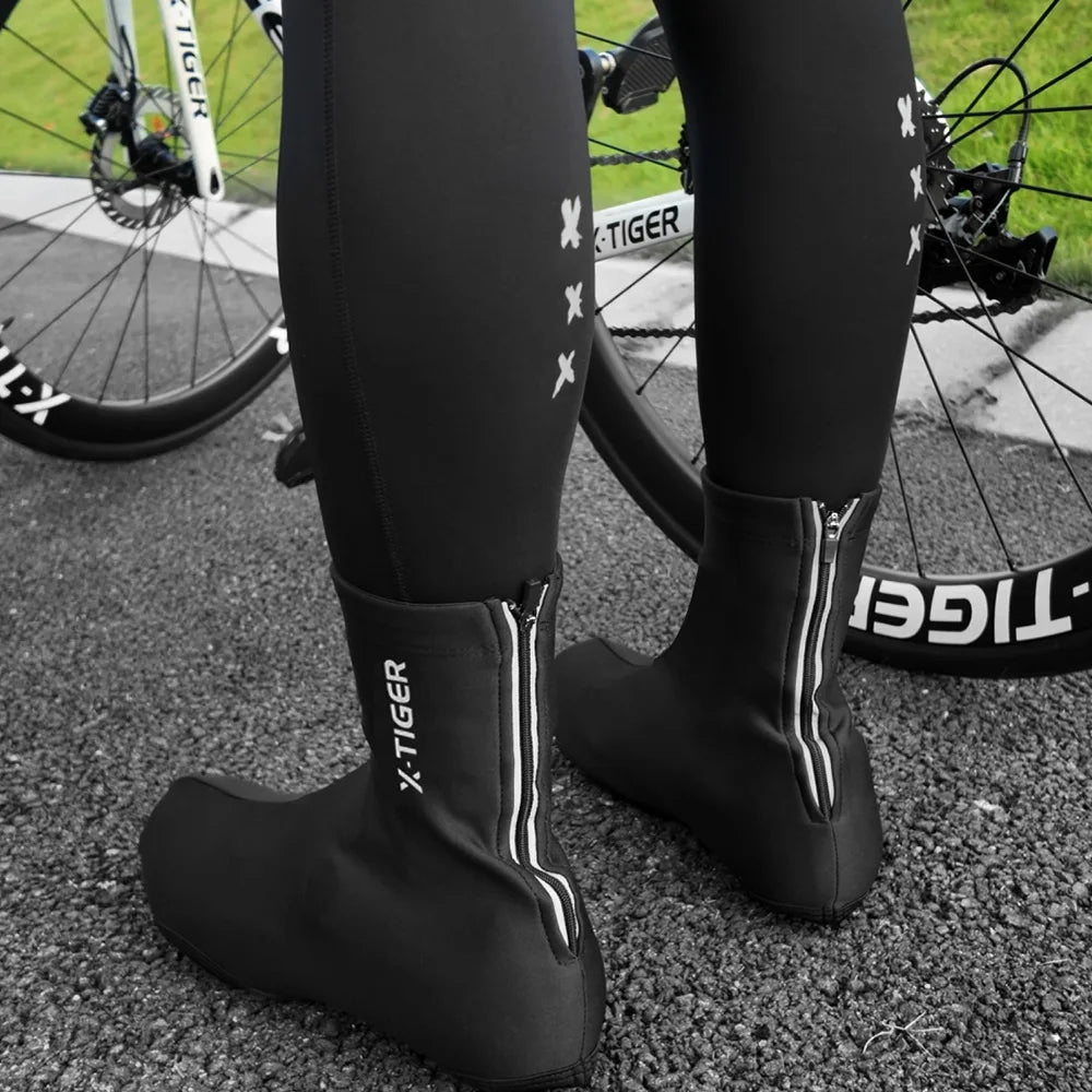 Black ankle cycling shoe covers with front zipper and elastic opening, pair view